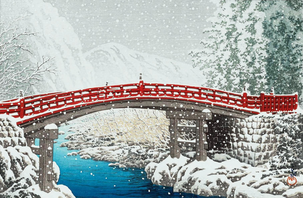 A view of Nikko's red-lacquered Kamibashi Bridge on a snowy winter's day. The bridge spans the icy-looking Daiya River in a gently curving arch; on either riverbank, leafless trees and tall pines crowd together, their branches plastered with snow. Snowflakes continue to fall across the scene; beyond, low mountains are hazy and indistinct, and the sky above is overcast