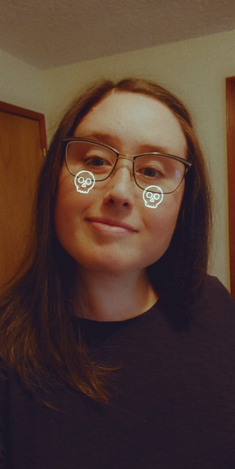 selfie of vigour_mortis, long brown hair, neon skull on cheeks filter