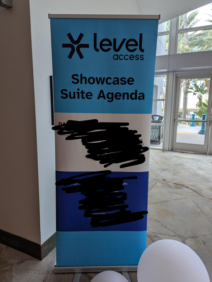 Level Access 7 foot tall banner outside its venue room, reading “showcase suite agenda.” I have blacked out the agenda.