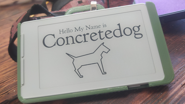 A small Xteink x4 ereader with my dogo logo and "Hello My Name is Concretedog" in text. 