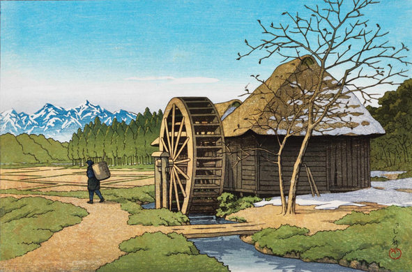 A rural scene somewhere near Mount Fuji, on a bright spring day. On our right, a wooden water wheel attached to a rustic thatched-roof building turns in a clear little stream; snow still clings to the shady side of the roof, and lingers in the building's shadow. A tall tree, its branches bare except for a few of the previous season's leaves, stands nearby. On our left, a single traveler carries a large basket on their back as they make their way along a winding path. Beyond, regular fields of farms stretch out toward a dense forest of evergreens; in the distance, snow-capped mountains reach into a clear blue sky.