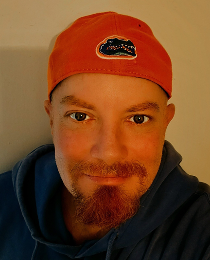 A man wearing an orange University of Florida Gators ballcap.