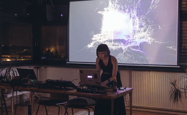 Live performance at pixel.forest() — Ploypapus Phosri aka. Ployz (@plyzitron) performing with real-time particle visuals projected behind her during our opening event in September 2025.