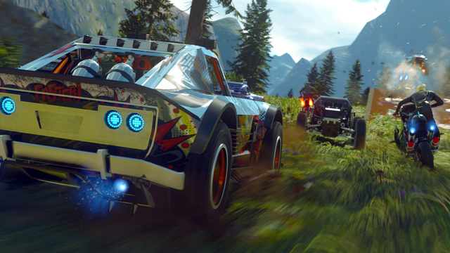 It's a screenshot from Onrush, a racing game. There's a fast car racing alongside a bike and another fast car. Nitrous is being used with a blue flame emitted from the exhaust. 