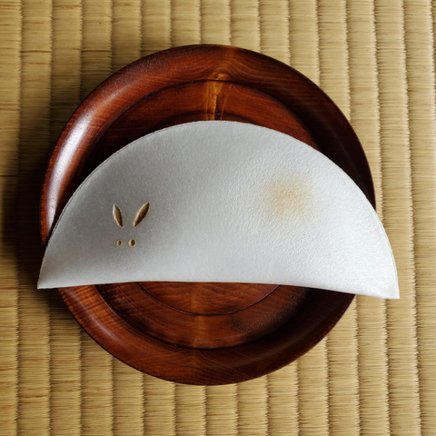 A half moon shaped, rabbit inspired oshiruko for the autumn full moon. The outer wafer is cracked open into a bowl spilling the powder and sugar inside. Hot water is added and the contents melt into a soup.