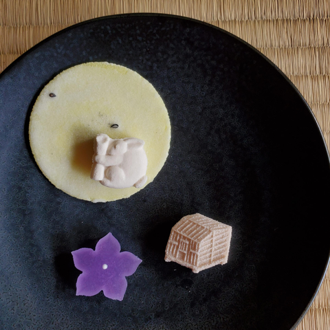 Dried sweets to celebrate the autumn full moon. A sugar rabbit pounds mochi on a cracker moon.