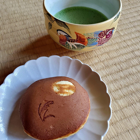 An autumn dorayaki (a pancake sandwich filled with bean paste), branded with autumn grass and a full moon.