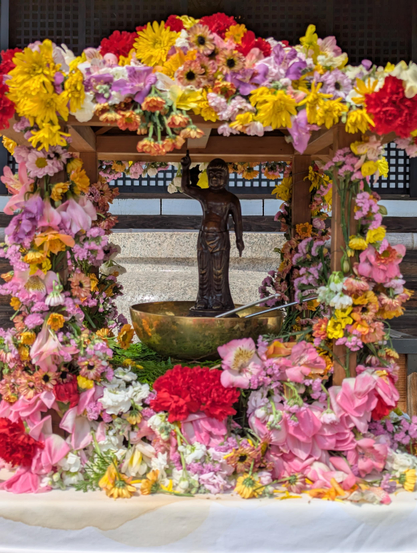 A small statue of Buddha as an infant is displayed by many temples on Buddha's Birthday. Worshipers pray by pouring sweet tea over the statue.