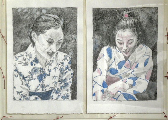 Two portraits side by side. They are both drawn in Conté pencil and lightly tinted with a supporting colour. Both are of young Japanese women in yukata. The person on the right is only a girl, around twelve at most; the one on the right could be in her thirties. They are both looking down an their faces are illuminated by some light source from below. The background is dark.