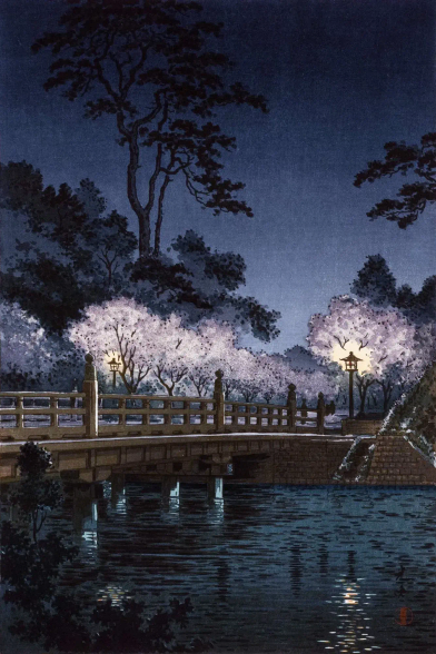 A view of Benkeibashi on a spring evening. On the far side of the footbridge, cherry trees in full bloom are lit from beneath by lanterns; beaneath the bridge, the waters of the Benkeibori (the outer moat of the Imperial Palace) are calm. Above, the sky is dark and starless.