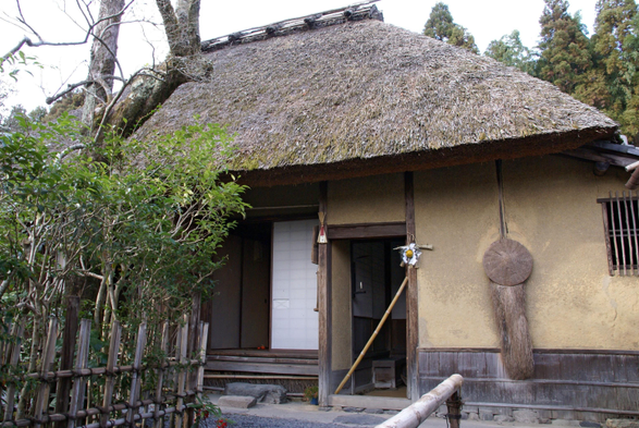 Straw raincoat and hat hanging at Rakushisha. Here is symbolises that the host is home.