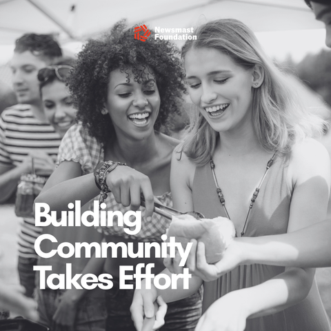 A black and white image of two women at a barbecue sharing food. Over it, text reads: Building Community Takes Effort. Newsmast Foundation.