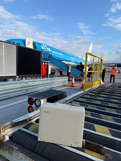A Toshiba luggable computer from 1993 on a baggage loader at the Schiphol airport. In the background a KLM plane which we just disembarked from.