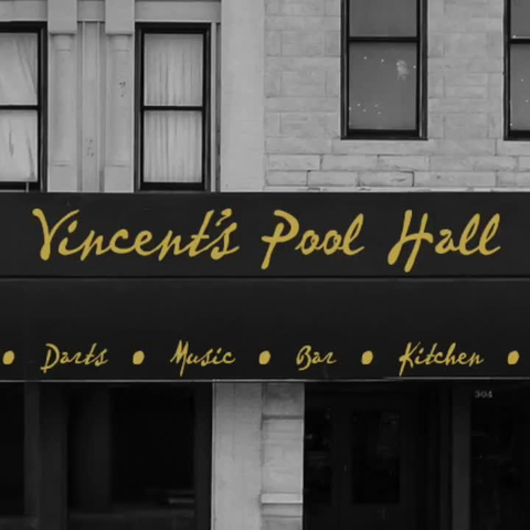 Black and white video with gold text pulling back from zoomed in using the “Ken Burns Effect”. The text on the awning reads “Vincent’s Pool Hall”.