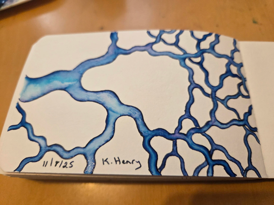 Hand drawn generative/procedural art in ink on an open page of my sketchbook. The abstract pattern is a simple branching fractal like curving tree branches and twigs.