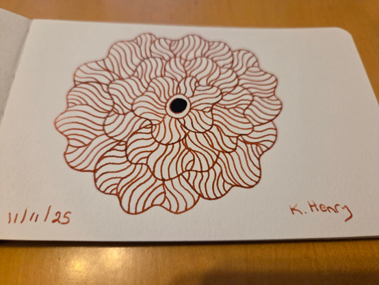 Hand drawn generative/procedural art in ink on an open page of my sketchbook. The abstract pattern is floral.