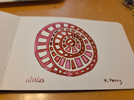 Hand drawn genertive/procedural art in ink on an open page of my sketchbook. The pattern has concentric but irregular circles with squares in them.