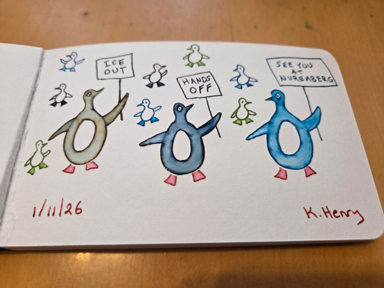 Hand drawn generative/procedural art in ink on an open page of my sketchbook. The abstract pattern looks like penguins of different colors holding up protest signs that read "Ice out", "Hands off", and "See you at Nuremburg". There are baby penguins behind the grown up penguins.