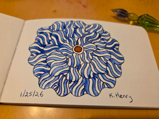 Hand drawn generative/procedural art in ink on an open page of my sketchbook. The abstract pattern is floral. My glass dipping pen is next to my sketchbook.