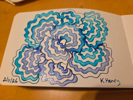 Hand drawn generative/procedural art in ink on an open page of my sketchbook. The abstract pattern looks a bit like a turkey tail mushroom.
