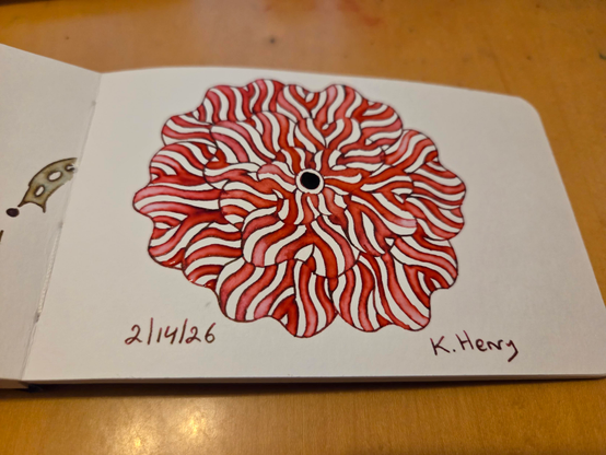 Hand drawn generative/procedural art in ink on an open page of my sketchbook. The abstract pattern is floral.