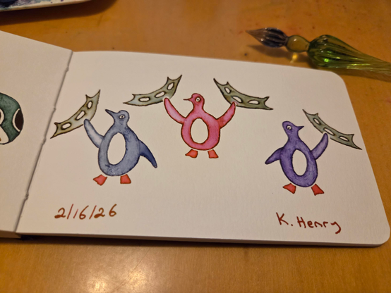 Hand drawn generative/procedural art in ink on an open page of my sketchbook. The abstract pattern looks like penguins wielding batleths. My glass dipping pen is next to my sketchbook.