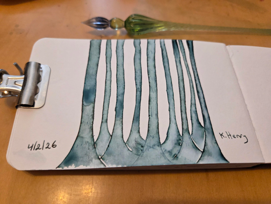 hand drawn generative/procedural art in ink on an open page of my sketchbook. The abstract pattern looks a bit like a bunch of very tall trees as if standing in front of them and the tops are too high to see. My glass dipping pen is next to my sketchbook, with is help open by a binder clip.