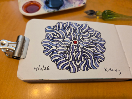 Hand drawn generative/procedural art in ink on an open page of my sketchbook, which is held open by a binder clip. My glass dipping pen and some inks are next to my sketchbook.