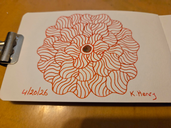 Hand drawn generative/procedural art in ink on an open page of my sketchbook. The abstract pattern is floral. A binder clip is holding the sketchbook open.