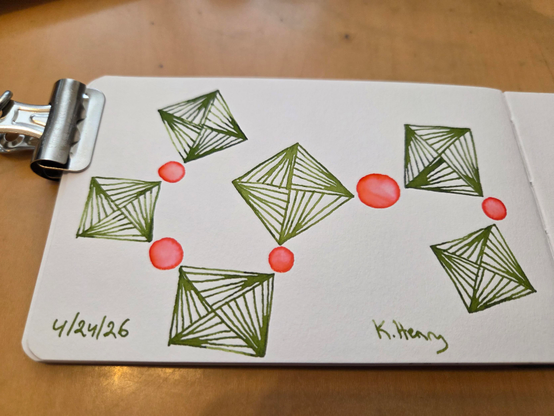 Hand drawn generative/procedural art in ink on an open page of my sketchbook. The abstract pattern is difficult to describe, but has circles and squares kind of like beads on a string. There is a binder clip holding the sketchbook open.