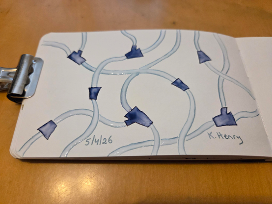 Hand drawn generative/procedural art in ink on an open page of my sketchbook. The abstract pattern looks a bit like medical tubing and connectors.