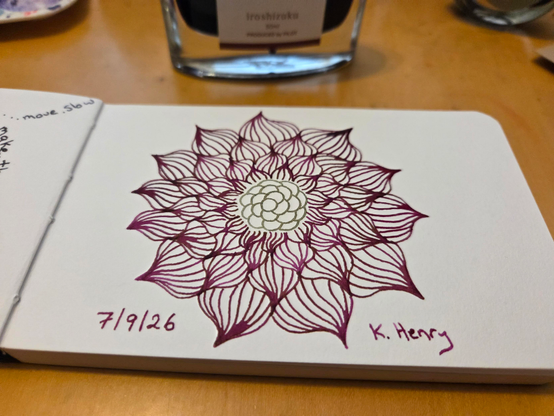 Hand drawn generative/procedural art in ink on an open page of my sketchbook. The abstract pattern is floral.