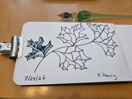 Hand drawn generative/procedural art in ink on an open page of my sketchbook. The abstract pattern looks  bit like leaves on a twig.