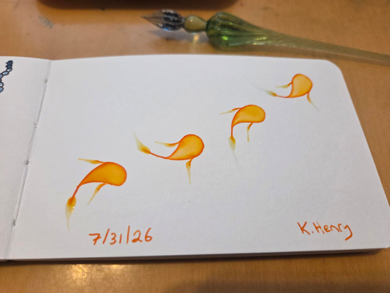 Hand drawn generative/procedural art in ink on an open page of my sketchbook. The abstract pattern looks like four little fish swimming in a line across the page. My glass dipping pen is next to my sketchbook.