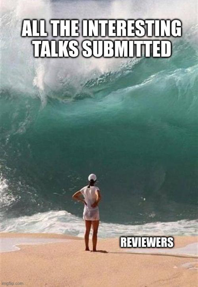 A person standing in front of a giant sea wave with the text next to the person saying 'reviewers' and the text on top of the wave saying 'all the interesting talks submitted'