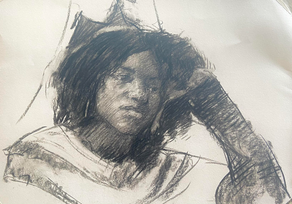Portrait of a young woman leaning on her hand. It’s done in charcoal.