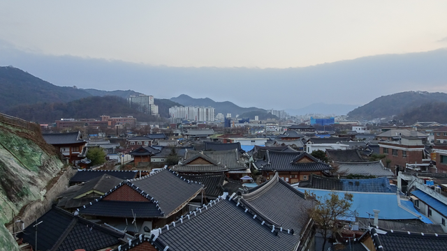 a view of the traditional hanok roofs of the jeonju hanok village on a misty day it's rather nice